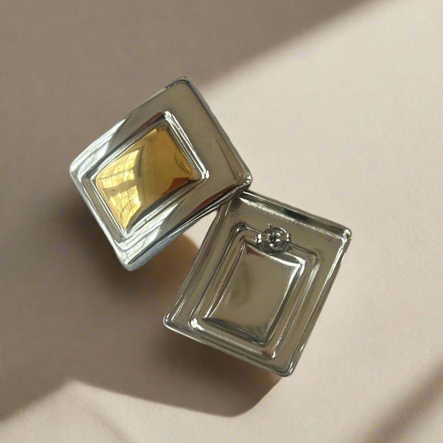 Mixed metal geometric statement earring.